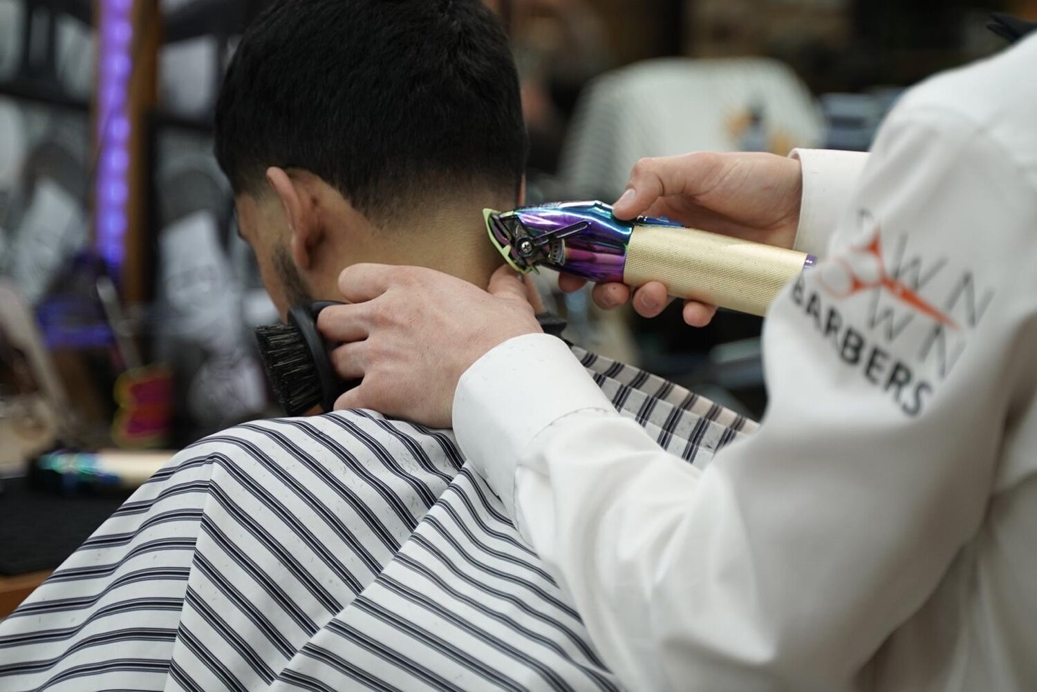 Barber som renser nakkelinjen hos Downtown Barbers